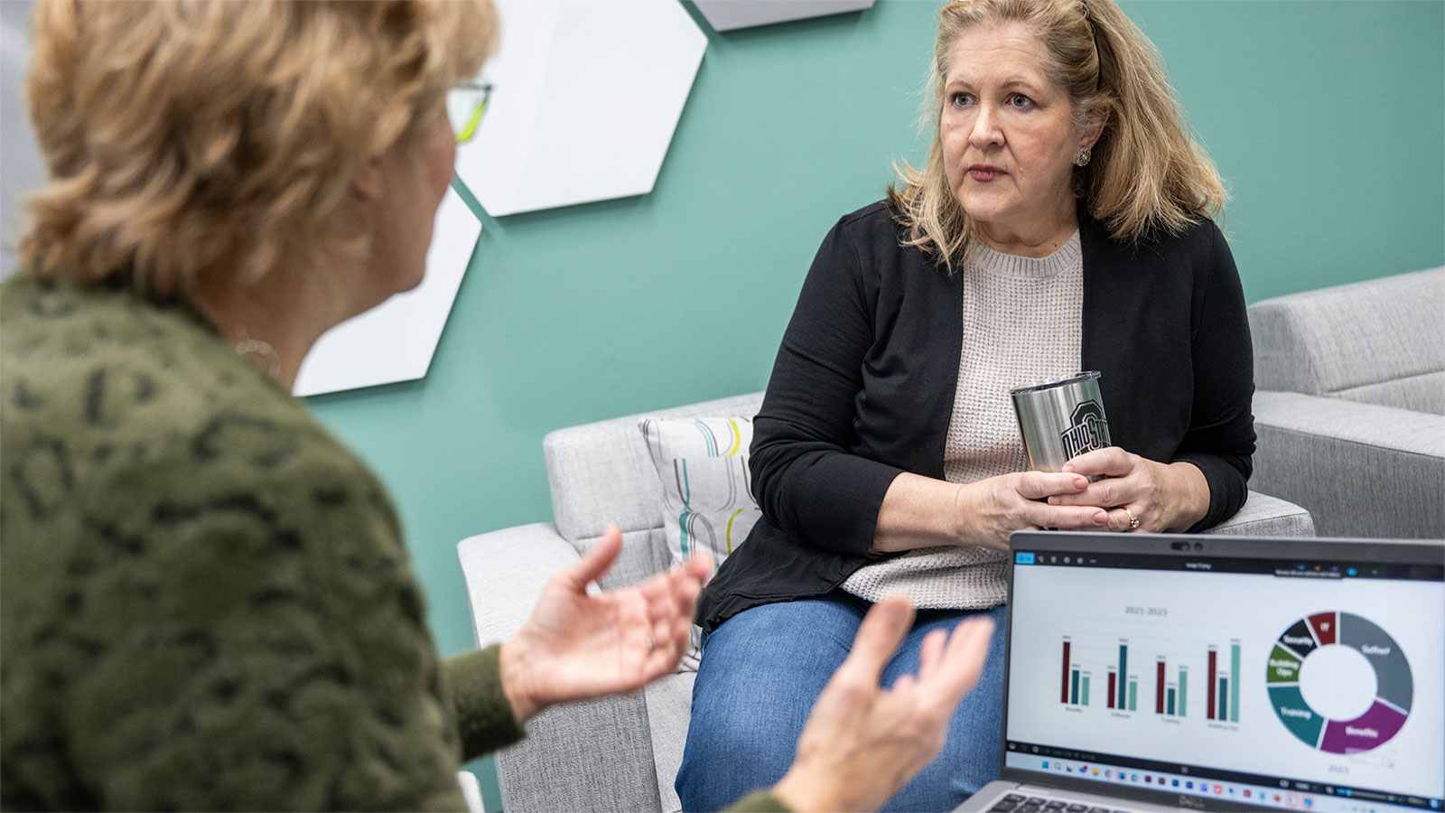 CHRR staffer and client collaborating, with data on a computer next to them